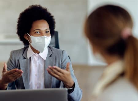 Doctor and patient talking with masks on